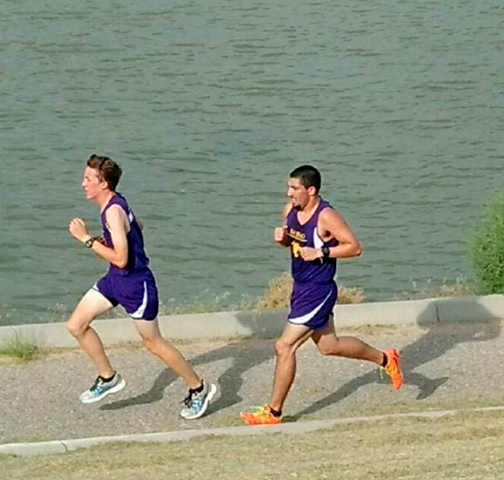 Students running along water while participating in Cross Country