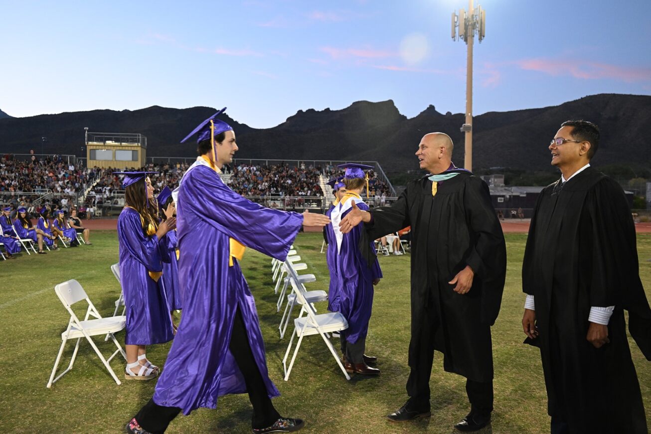 A Sabino grad walks up to shake hands with the principal