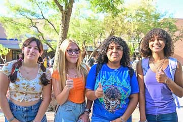 Students give a thumbs up on opening day.