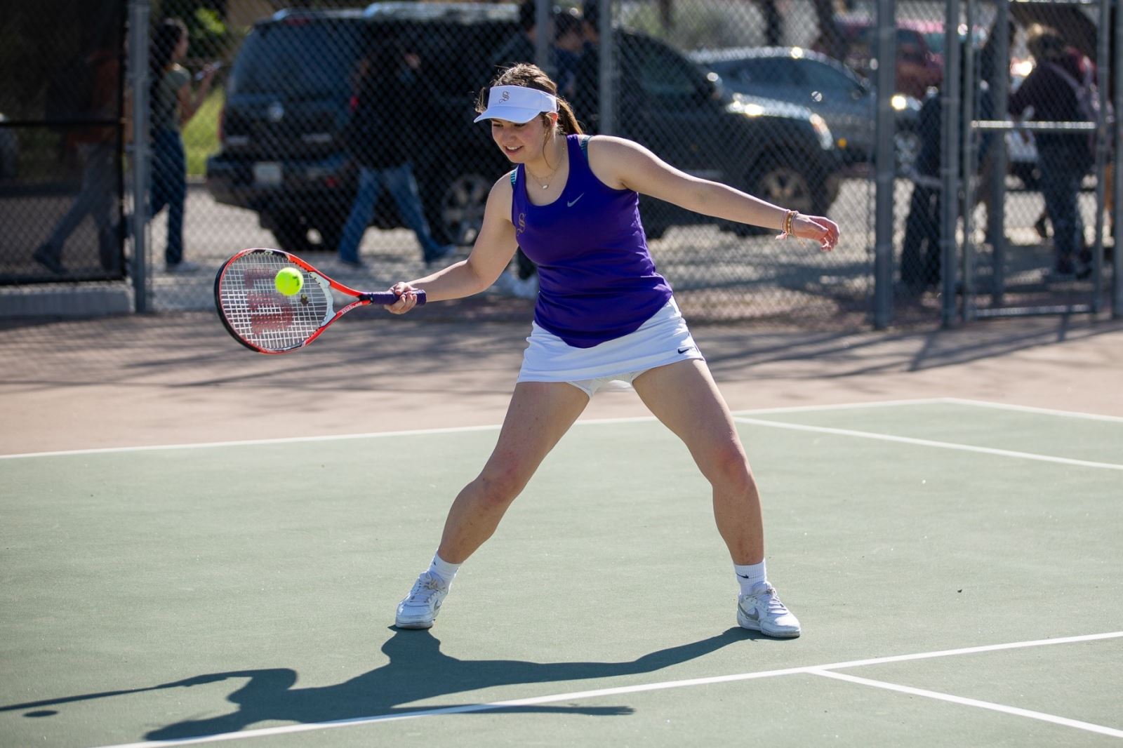 A Sabino girls tennis player gets her racquet on the ball.