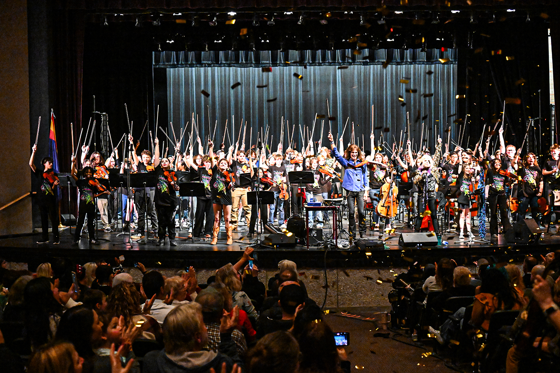 Mark Wood performs on stage with students