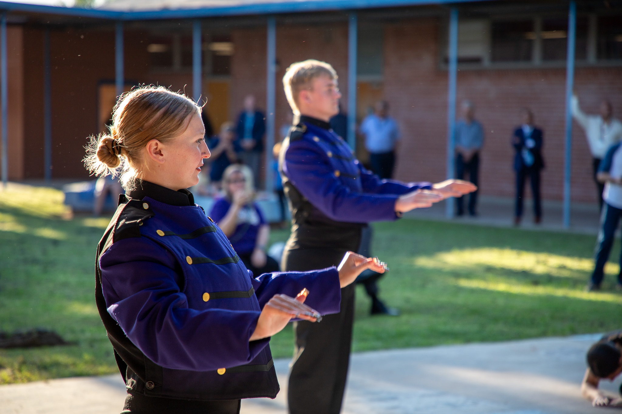 The drum majors lead the marching band outside the Governing Board meeting