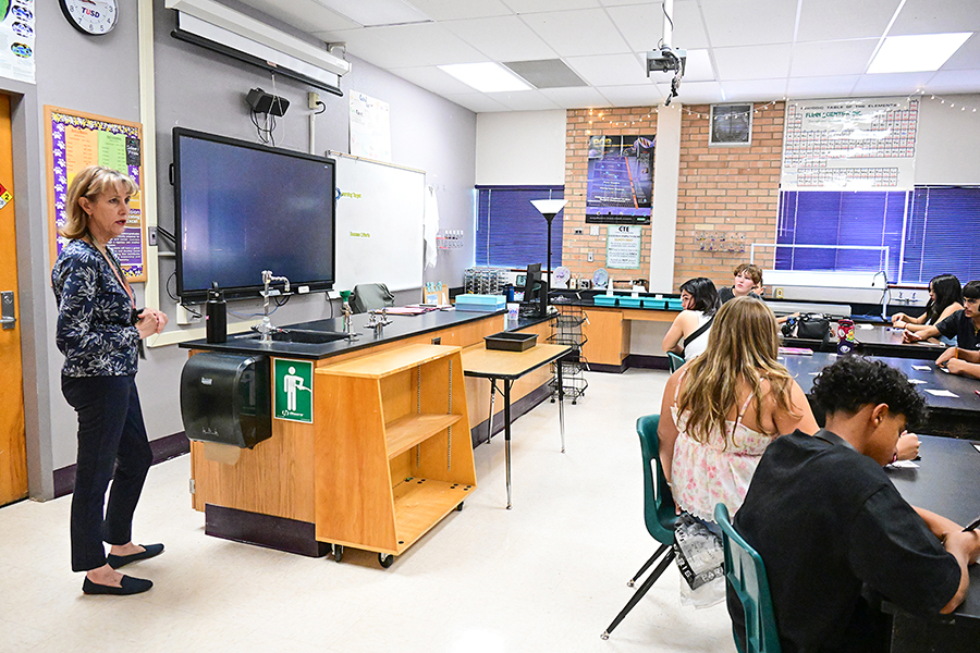 A teacher talks to her class