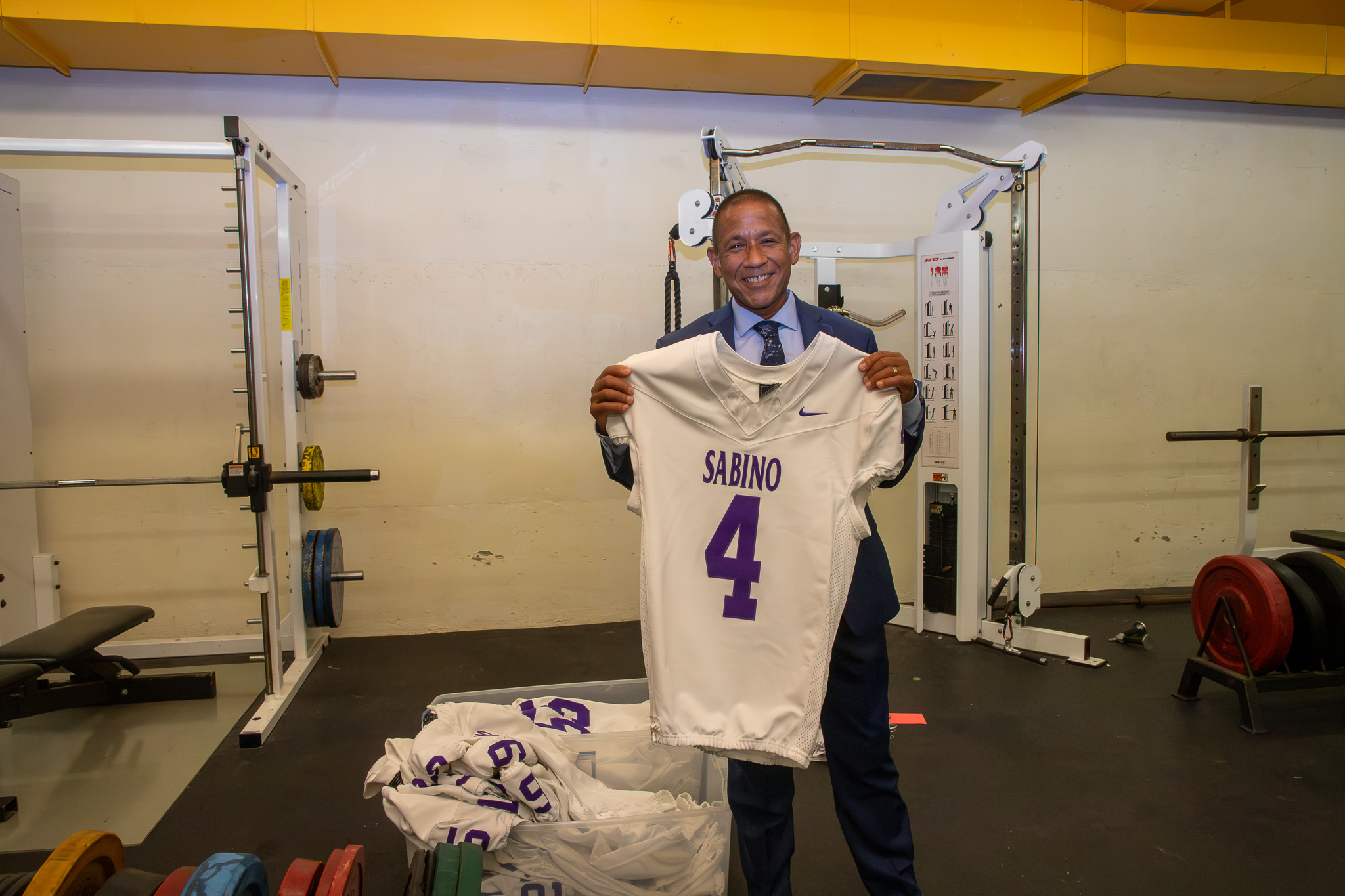 Dr. Trujillo holds up a football jersey