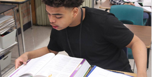 A Student Studies His Math Book