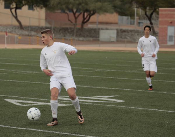 Soccer player kicking a ball during soccer game