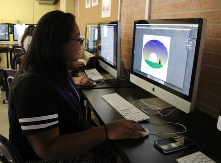 Student at computer working on a graphic design logo